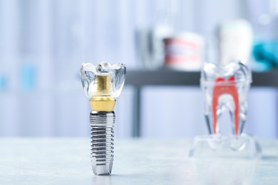 Photo of Educational model of dental implant on light table indoors. Space for text