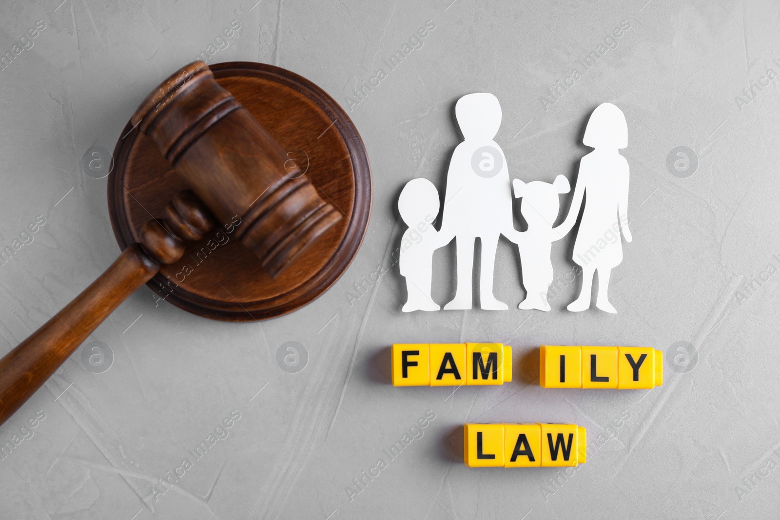 Photo of Flat lay composition with figure and gavel on grey background. Family law concept