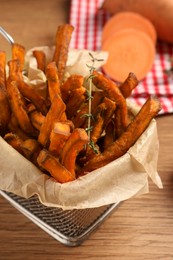 Sweet potato fries on wooden table, closeup