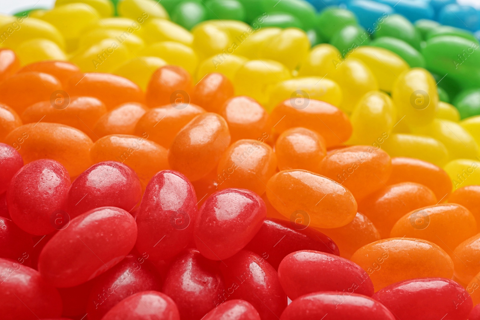 Photo of Tasty bright jelly beans as background, closeup