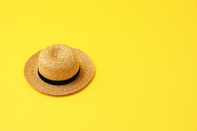 Stylish hat on yellow background, space for text. Summer beach accessories