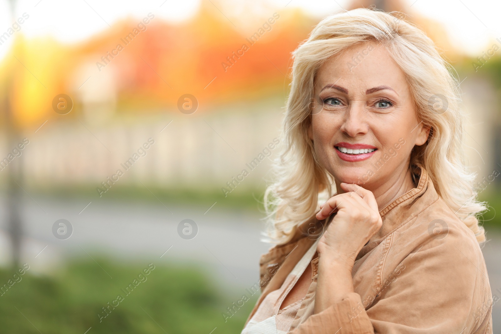 Photo of Portrait of happy mature woman on city street