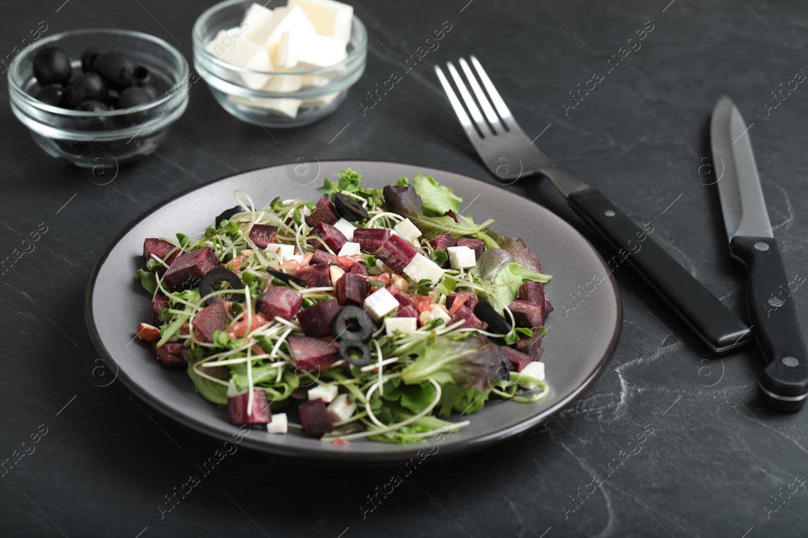 Photo of Delicious carrot salad served on black table