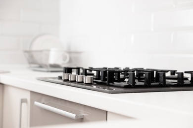 Modern built-in gas cooktop in light kitchen