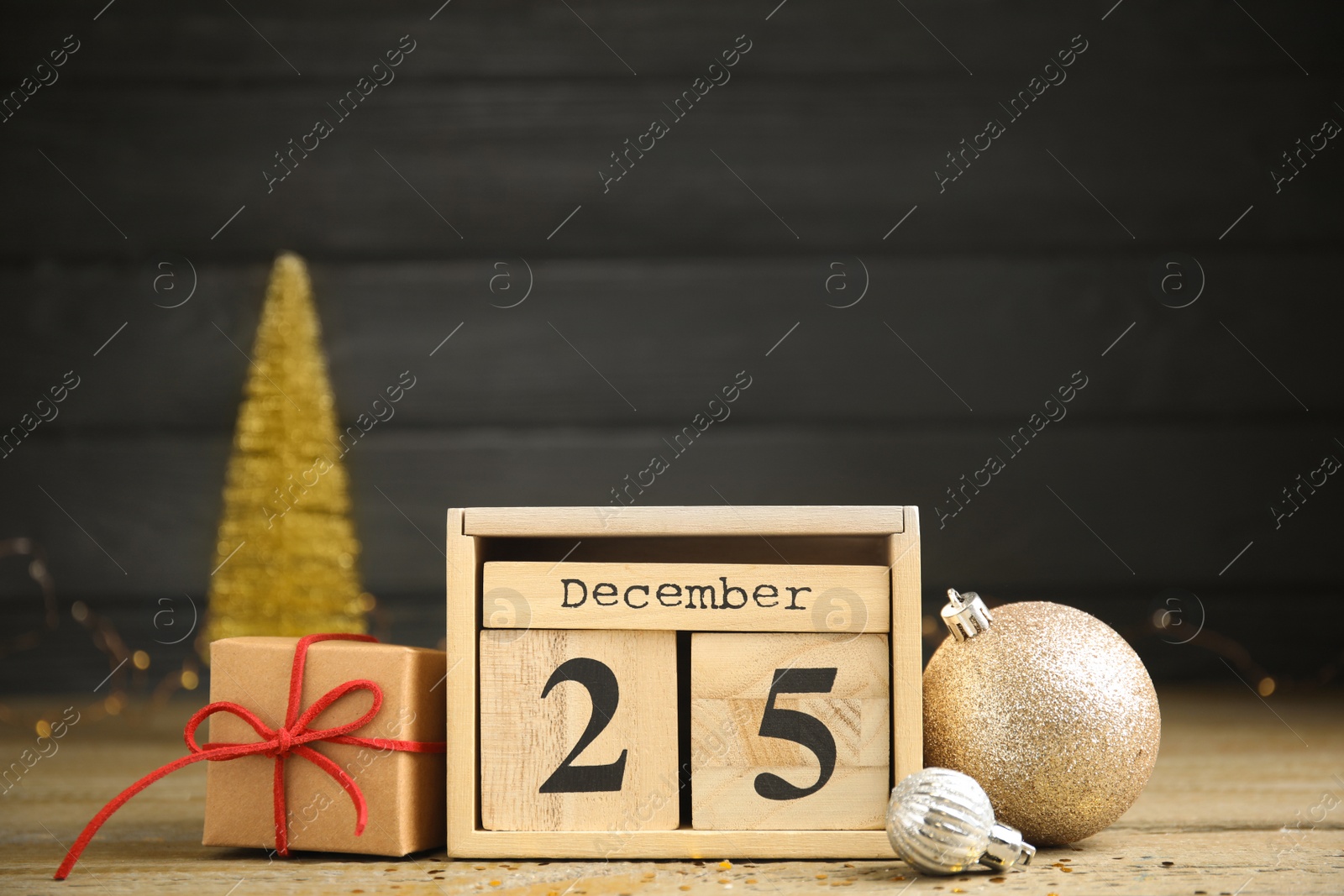 Photo of Block calendar and festive decor on wooden table