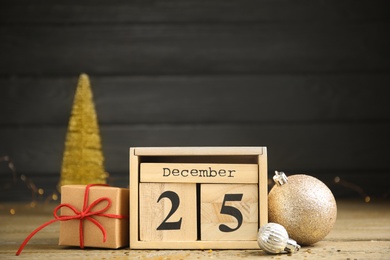 Photo of Block calendar and festive decor on wooden table