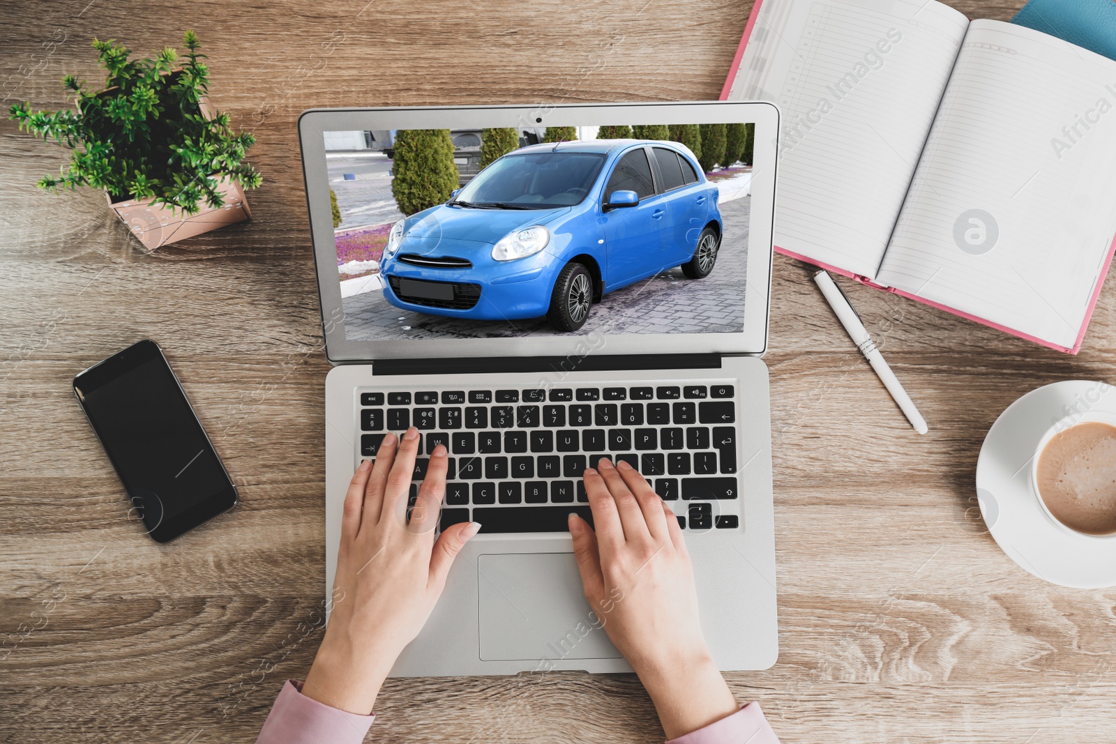 Image of Buying online. Woman choosing car using laptop, top view
