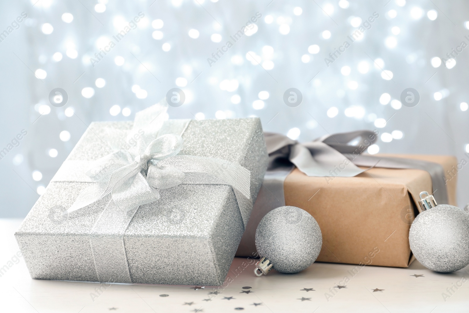 Photo of Christmas gifts on table against blurred background