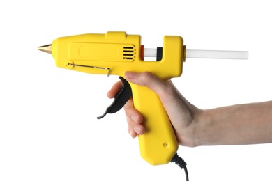 Photo of Woman holding yellow glue gun with stick on white background, closeup