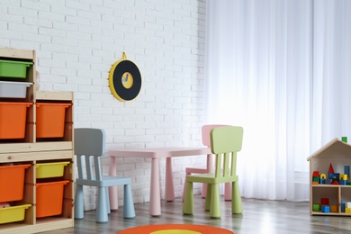 Photo of Modern child room interior with table and chairs