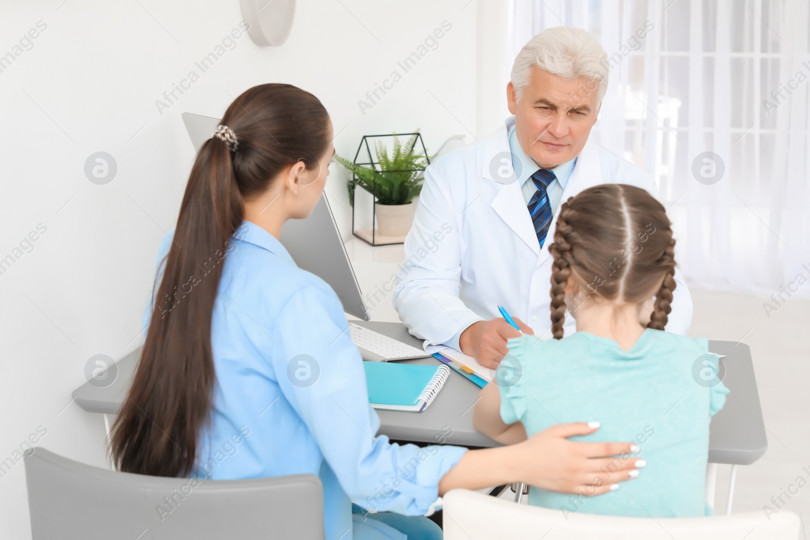 Photo of Young woman with her daughter having appointment at child psychologist office