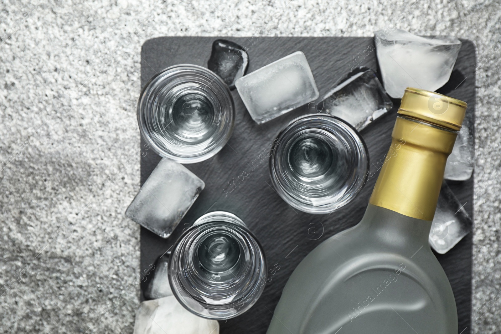 Photo of Cold Russian vodka on grey table, flat lay