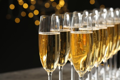 Glasses of champagne against blurred lights, closeup. Bokeh effect