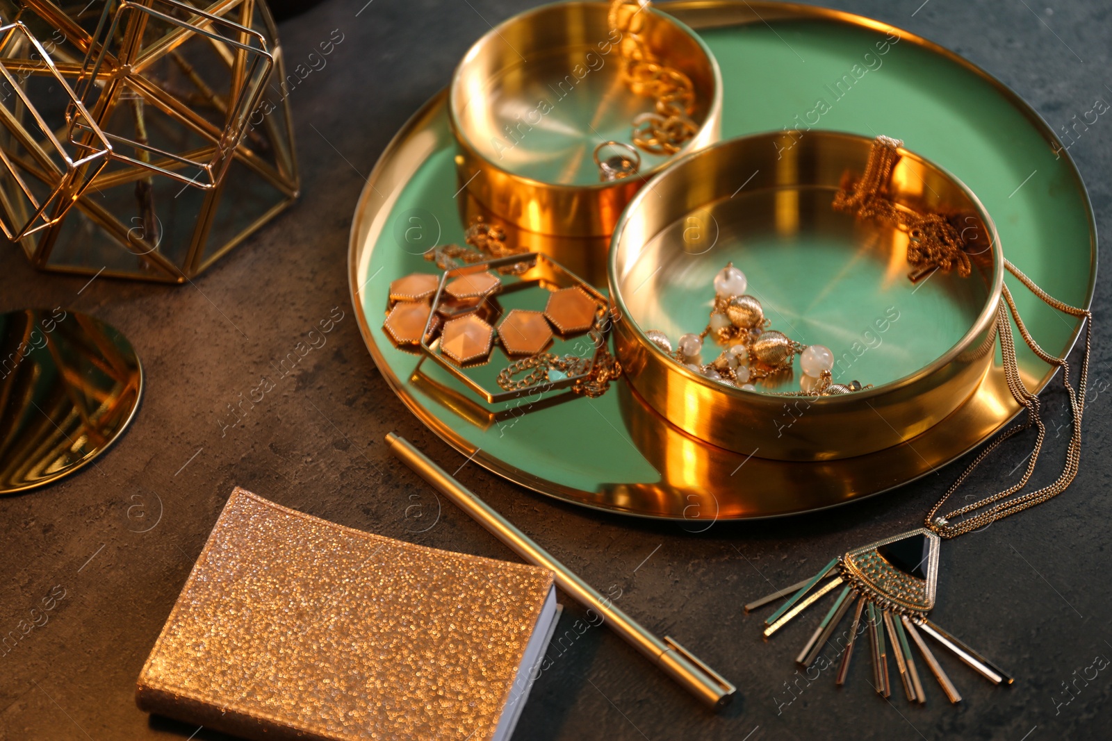 Photo of Composition with stylish accessories on grey table. Interior elements