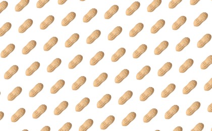 Pattern of unpeeled peanuts on white background