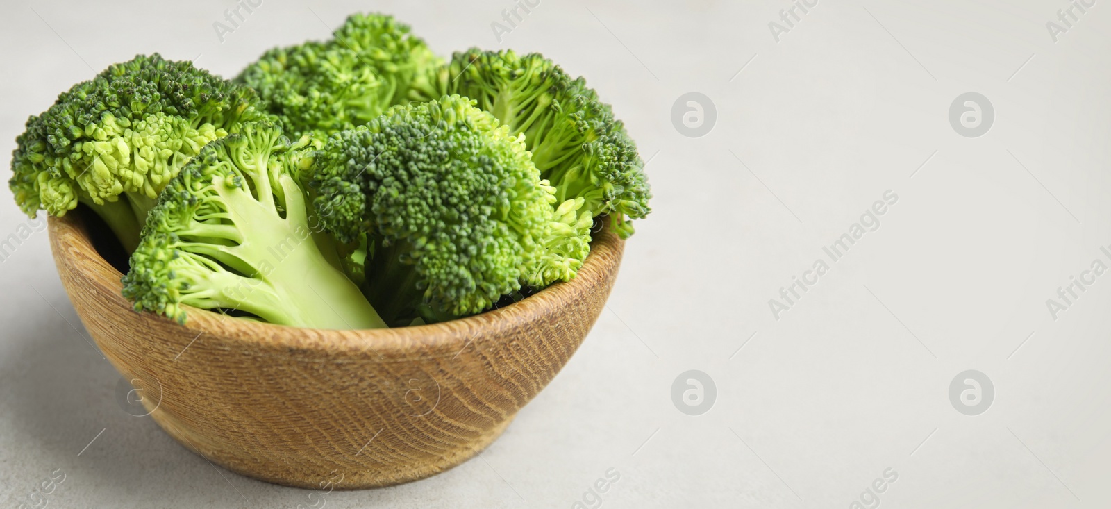 Image of Fresh green broccoli on light table, space for text. Banner design 