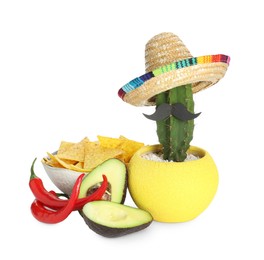 Photo of Cactus with Mexican sombrero hat, fake mustache, chili peppers, cut avocado and nachos chips in bowl isolated on white