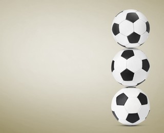 Image of Stack of soccer balls on beige background. Space for text