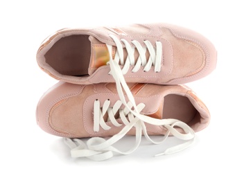 Photo of Stylish pink sneakers with shoelaces on white background