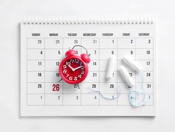 Photo of Calendar, tampons and clock on white background, top view. Gynecology concept