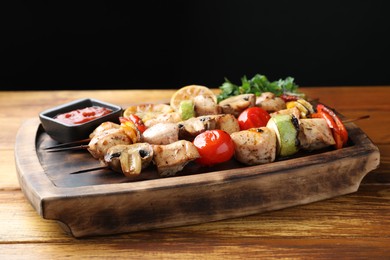 Photo of Delicious shish kebabs with grilled vegetables served on wooden table