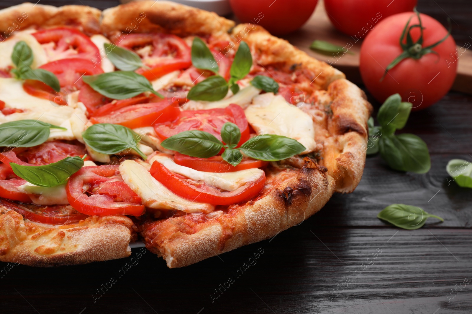 Photo of Delicious Caprese pizza on wooden table, closeup