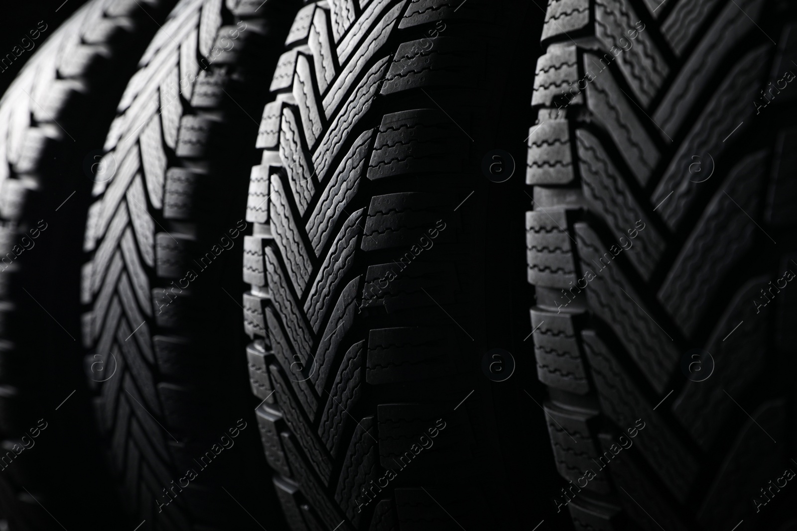 Photo of Set of new winter tires as background, closeup