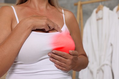 Image of Woman doing breast self-examination in bathroom, closeup