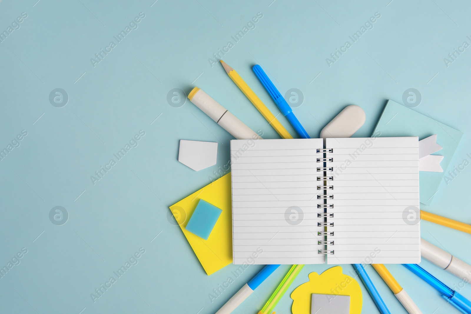 Photo of Different school stationery on light blue background, flat lay with space for text. Back to school