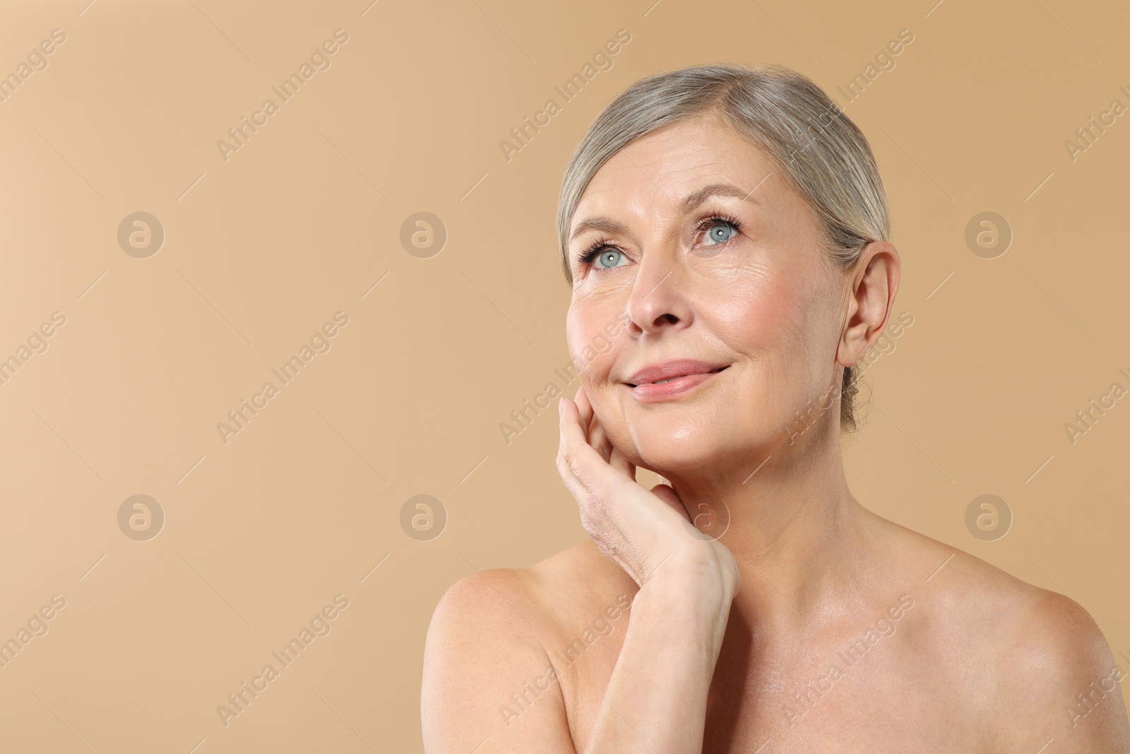 Photo of Beautiful mature woman with healthy skin on beige background, space for text