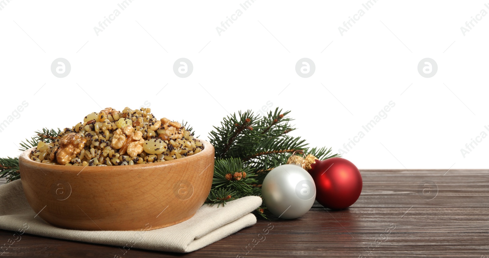 Photo of Traditional Christmas slavic dish kutia and festive decor on wooden table against white background
