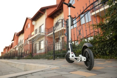 Photo of Modern electric kick scooter on city street
