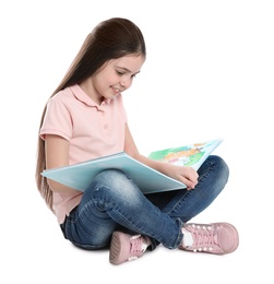 Cute little girl reading book on white background