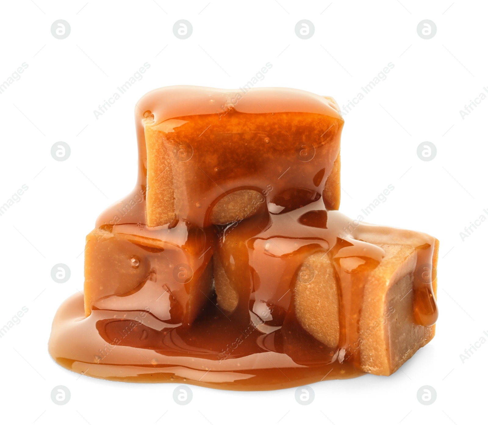 Photo of Delicious candies with caramel sauce on white background