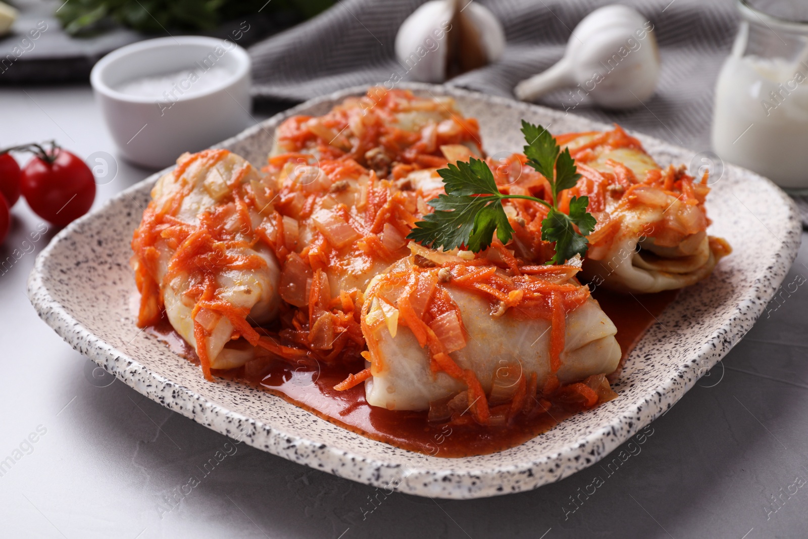 Photo of Delicious cabbage rolls served on grey table, closeup