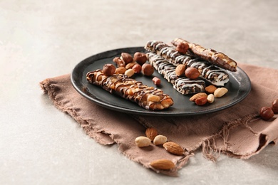 Photo of Homemade grain cereal bars with chocolate and nuts on plate