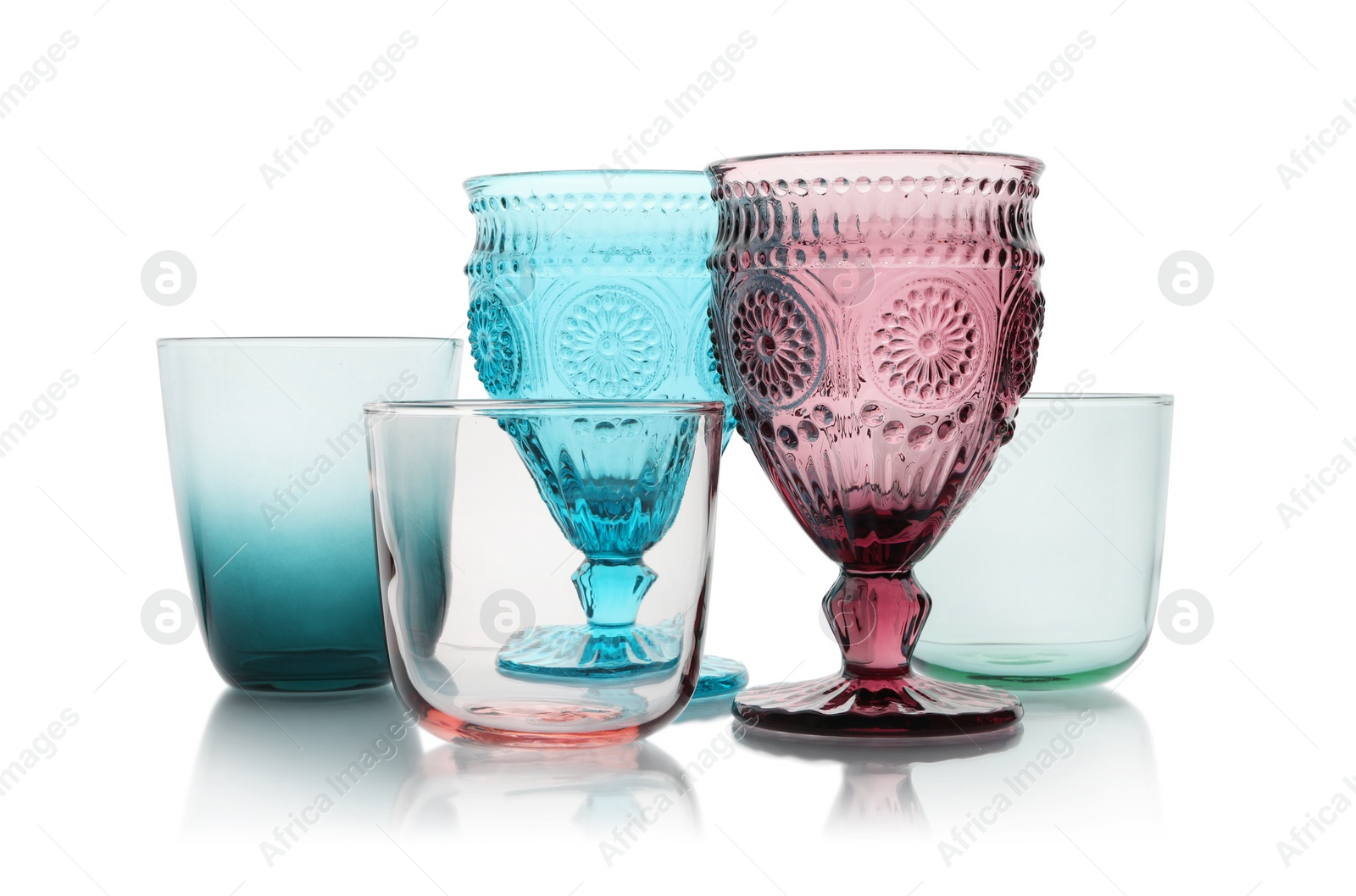 Photo of Set of colorful empty glasses on white background