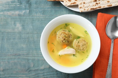 Photo of Flat lay composition with Jewish matzoh balls soup on wooden table. Space for text