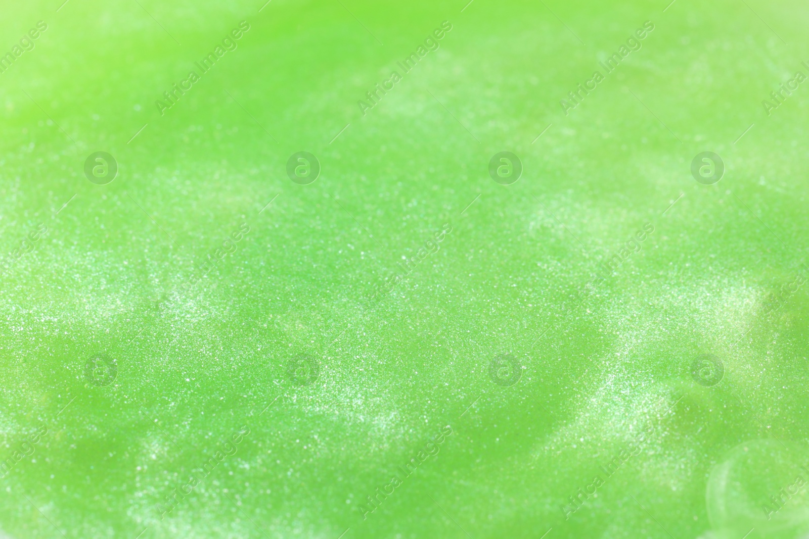 Photo of Closeup view of green slime as background. Antistress toy