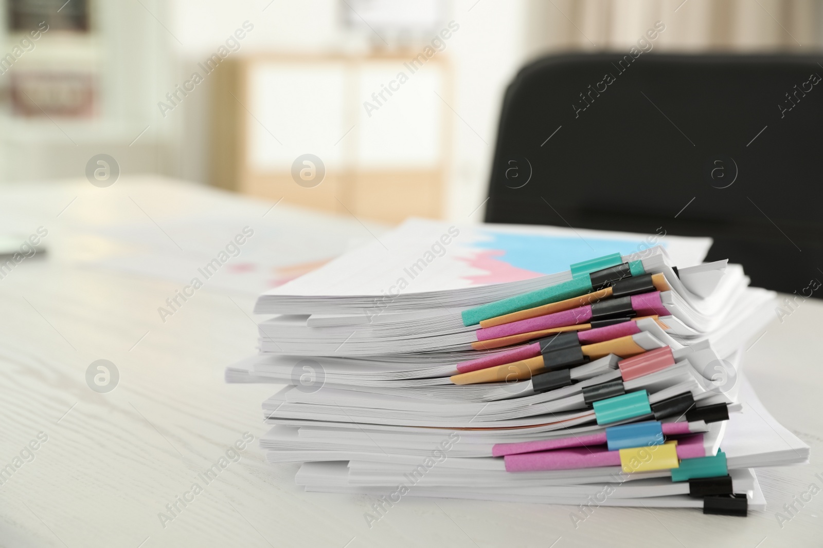 Photo of Stack of documents with paper clips on office table