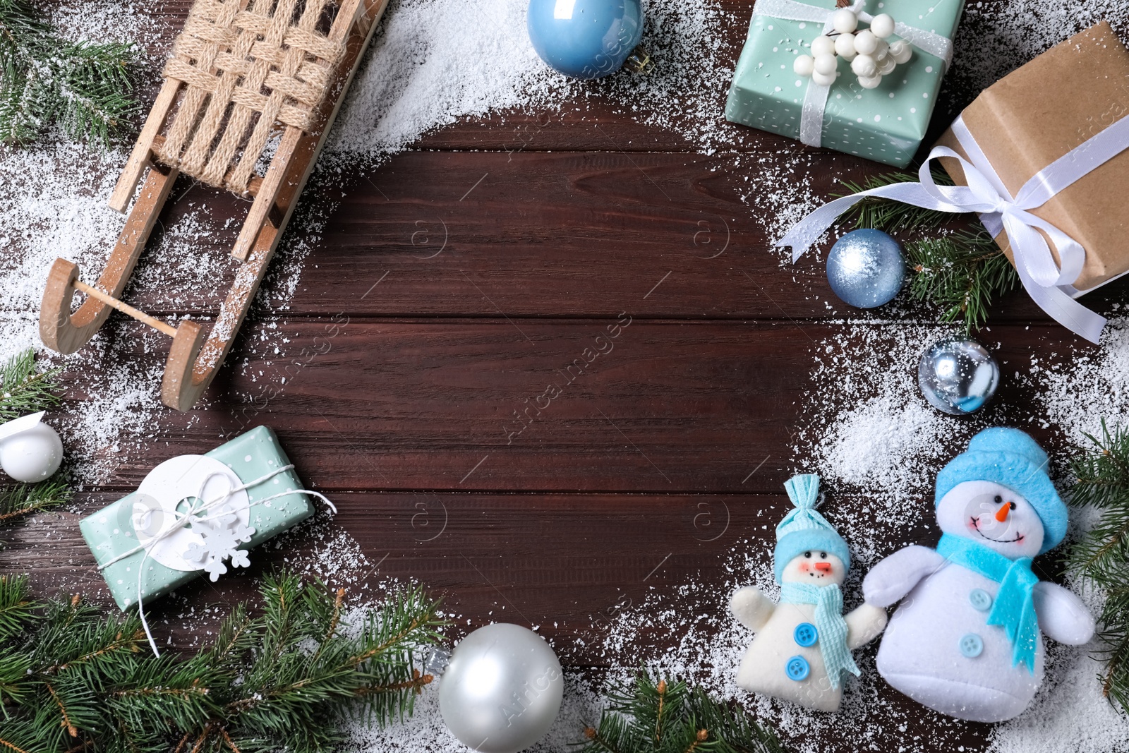 Photo of Flat lay composition with sleigh, Christmas decorations and gift boxes on wooden table. Space for text