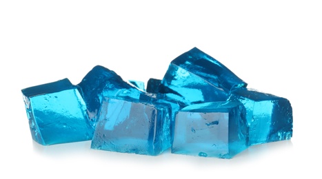 Heap of blue jelly cubes on white background