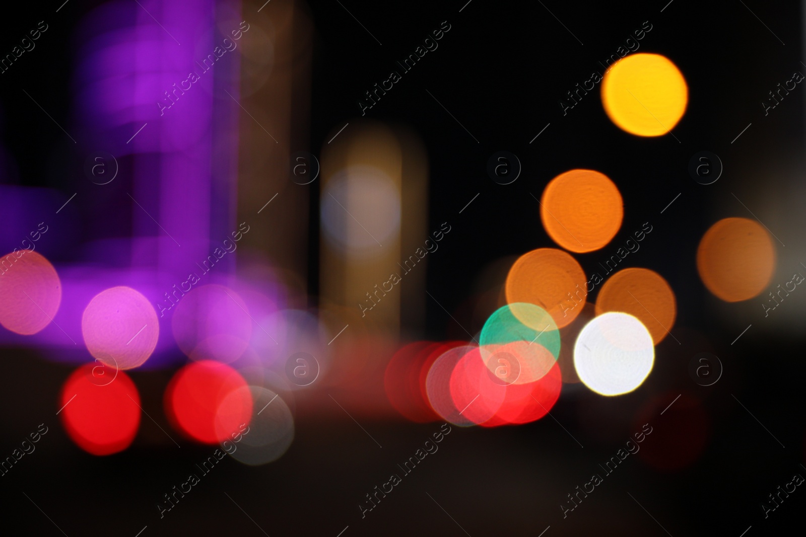 Photo of Blurred view of cityscape with bokeh effect. Night life