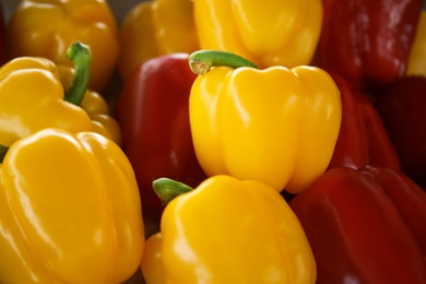Photo of Closeup view of fresh ripe colorful bell peppers as background