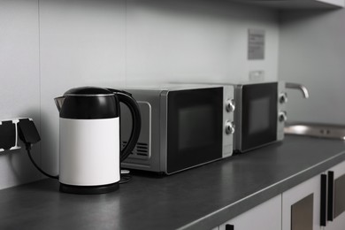 Photo of Kitchen appliances on grey countertop in hostel