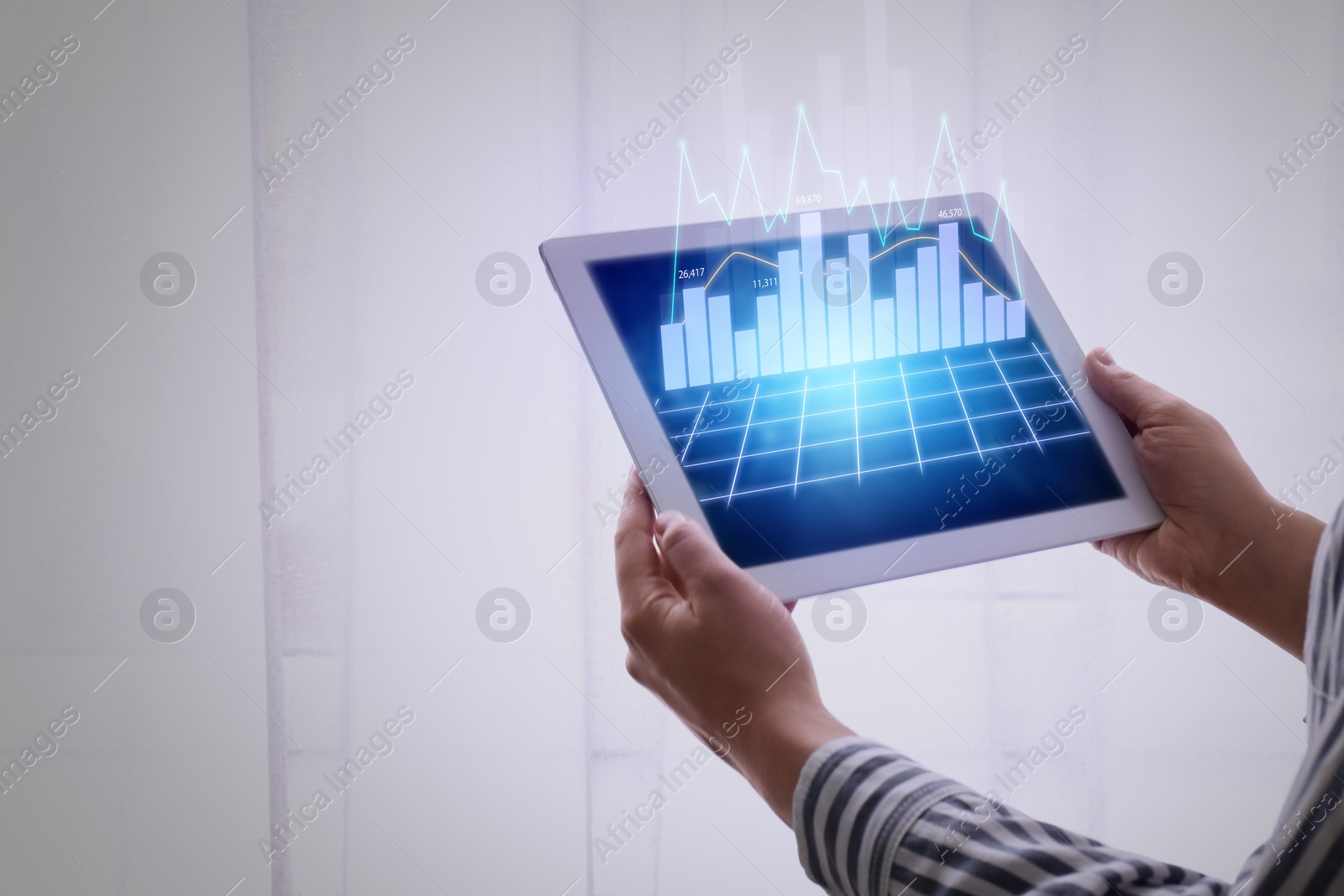 Image of Fintech concept. Woman working with tablet and digital graphic, closeup