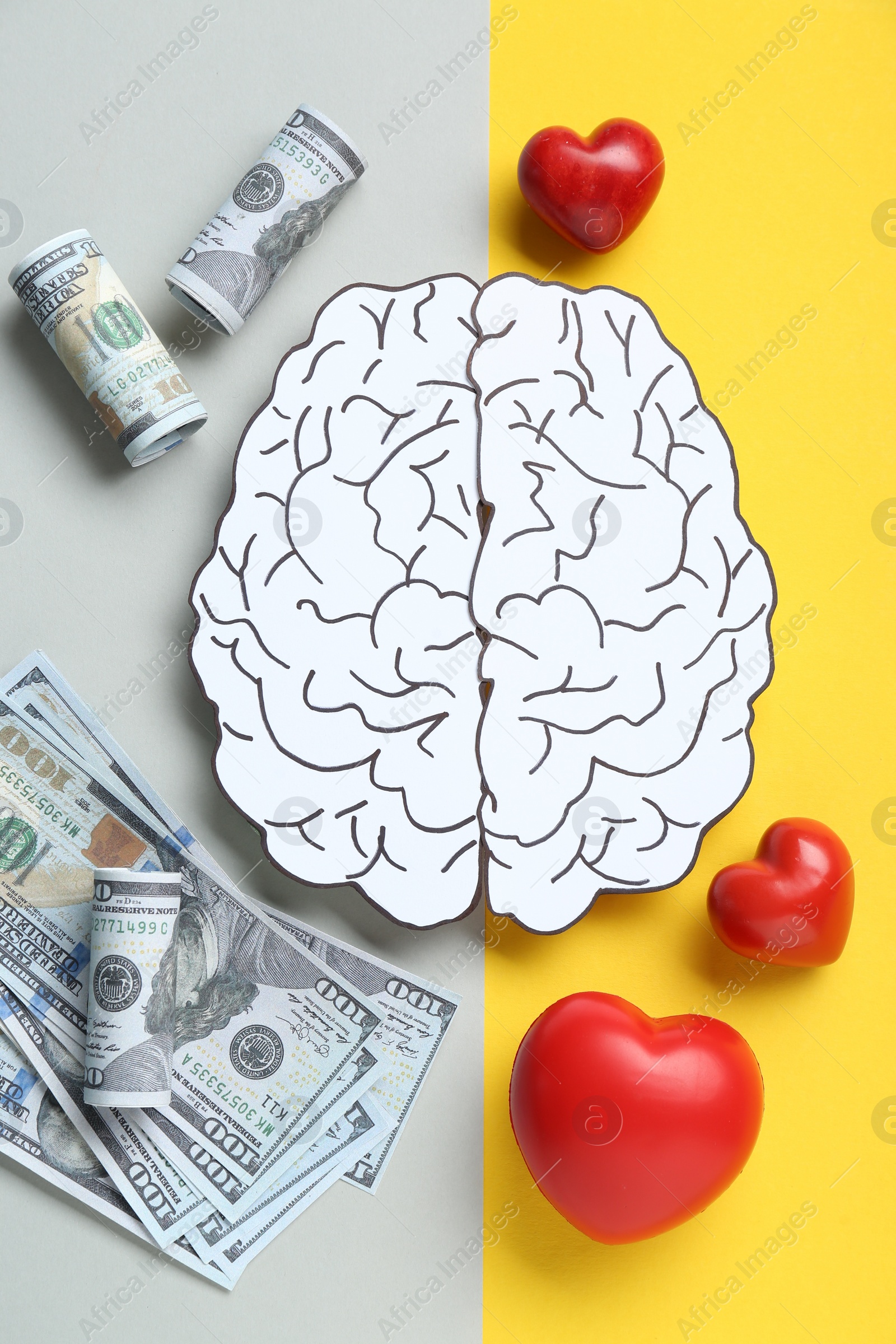 Photo of Emotional and rational. Paper human brain, dollar banknotes and red hearts on color background, flat lay