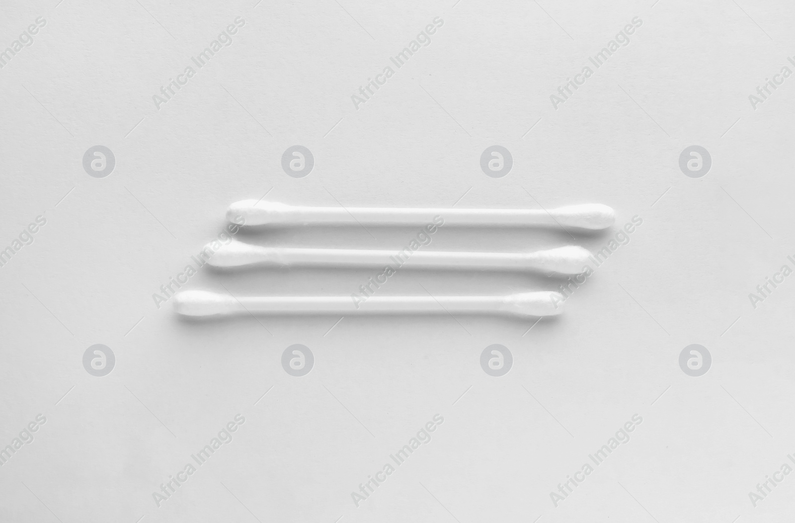 Photo of Clean cotton buds isolated on white, top view