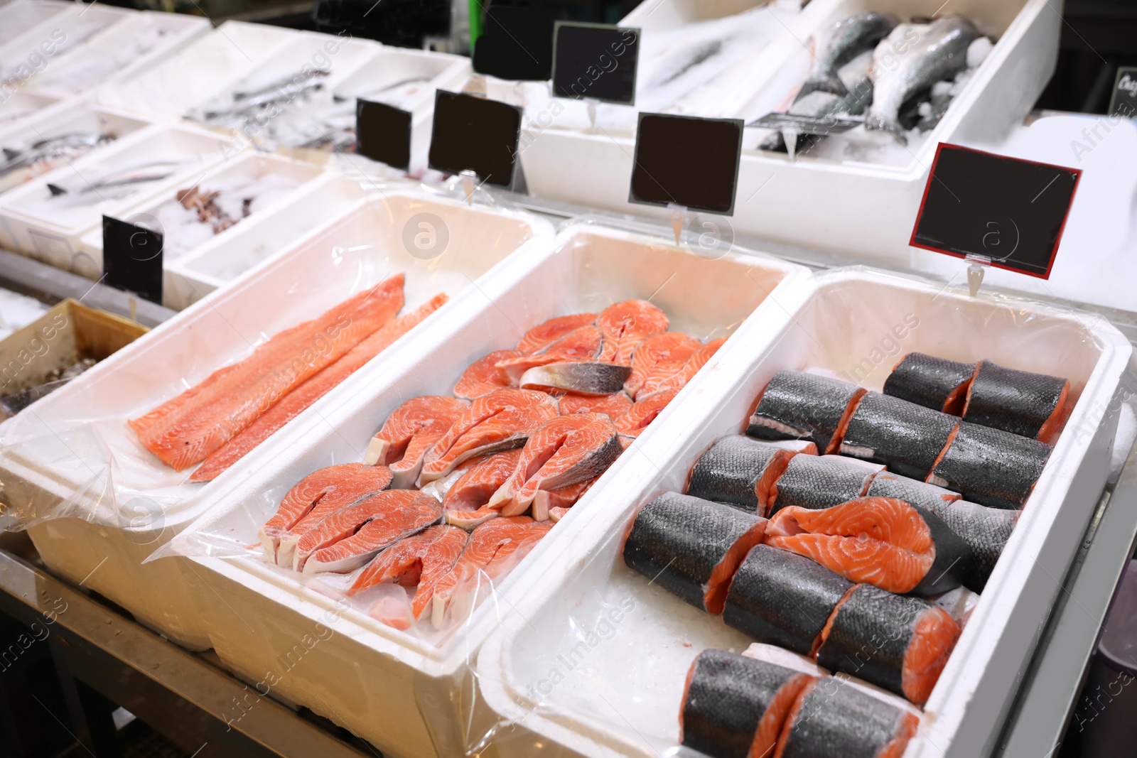 Photo of Fresh fish on display with ice at wholesale market