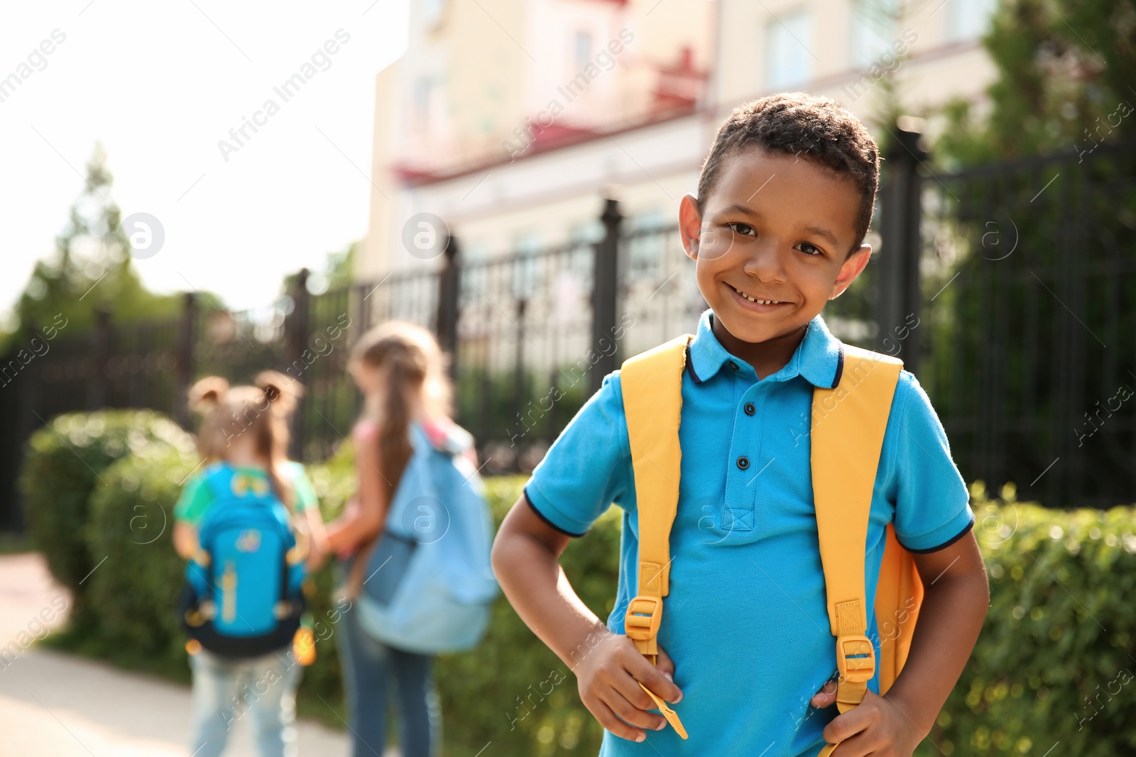 Photo of Cute little child with backpack outdoors. Elementary school